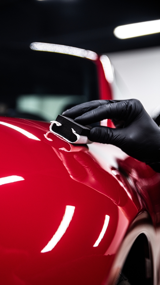 Car detailing finish in Hanford CA Hand applying protective finish to a vehicle exterior after a car wash service